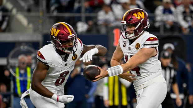 Washington Commanders running back Brian Robinson Jr. (8) and quarterback Sam Howell (14) in action during the game between the Dallas Cowboys and the Washington Commanders at AT&T Stadium.